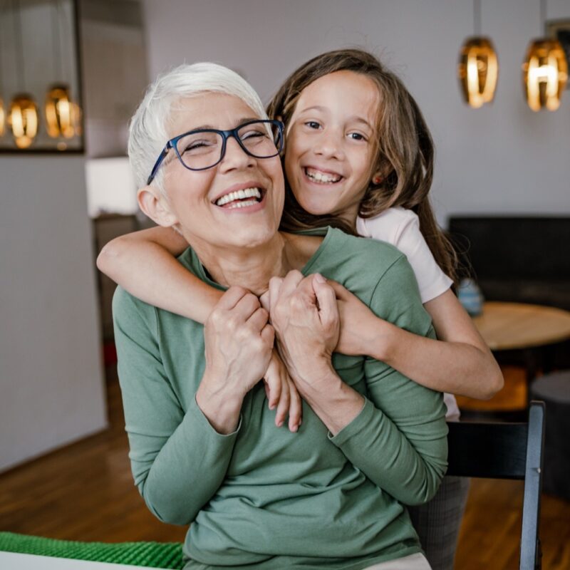 Cute girl hugging her grandmother